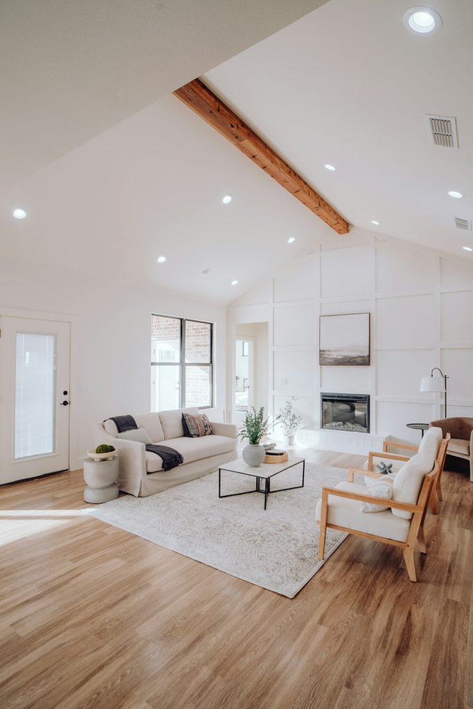 a-living-room-with-a-couch-a-chair-and-a-fireplace-qq6xmtxxfz8