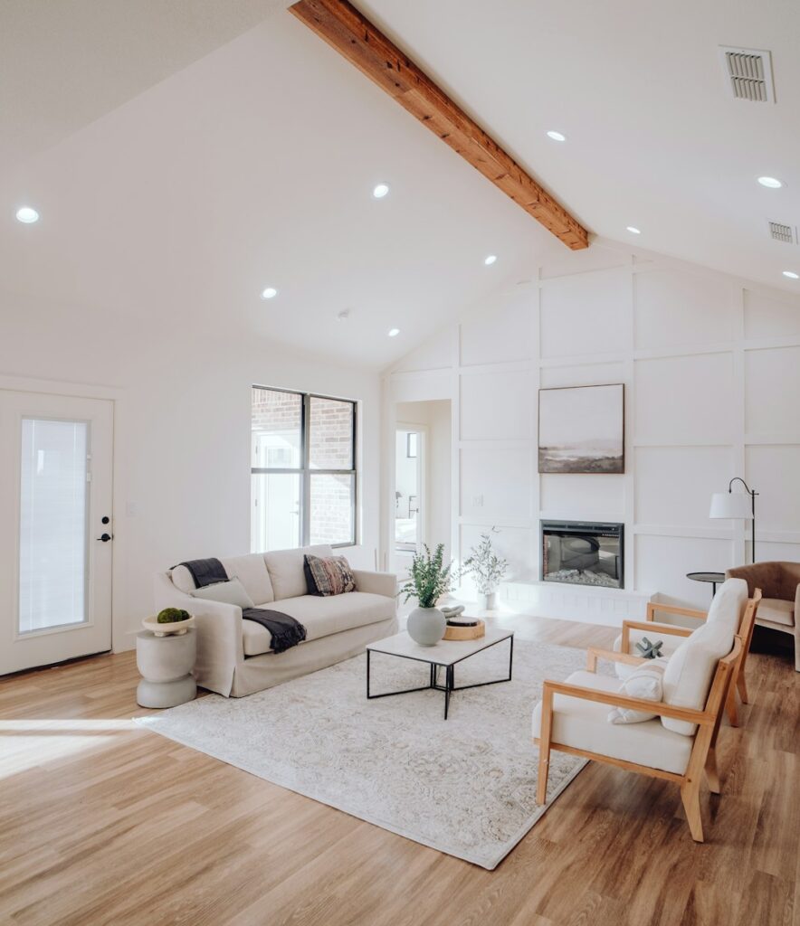 a-living-room-with-a-couch-a-chair-and-a-fireplace-qq6xmtxxfz8
